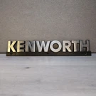 Kenworth Truck Hood Emblem K281-1348 Black & Silver 14" X 2.5". Fixed Price $48.99.